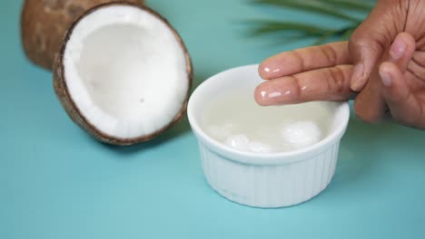 Hand-pick-coconut-oil-from-a-container-,