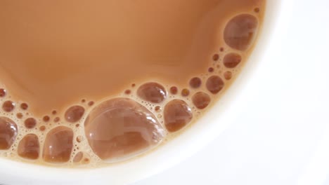 Close-up-of-cup-of-milk-tea-on-table-,