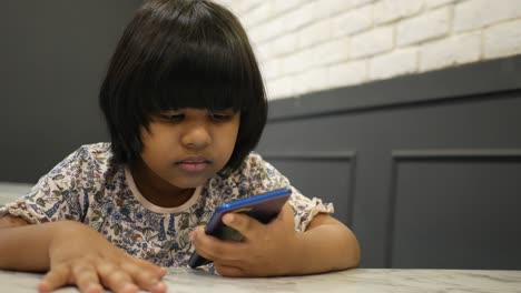 Child-girl-watching-cartoon-on-smart-phone-,