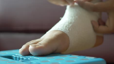 Woman-feet-with-bandaged-on-floor-,