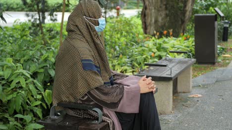 Thoughtful-muslim-woman-with-flu-mask-outdoor-,
