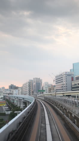 tokyo-monorail-passing-through-the-city's-skyscapers-in-vertical