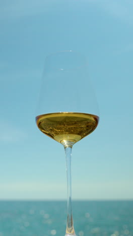 A-glass-with-white-wine-and-sparkling-sea