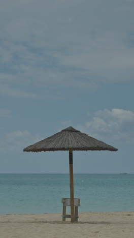maragkas-beach-in-naxos-island-greece-with-sun-umbrellas-in-vertical
