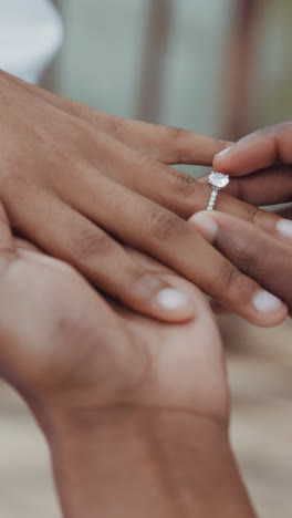 Couple,-holding-hands-and-ring-for-wedding