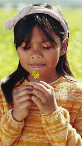 Flower,-smell-and-portrait-of-child-in-a-garden