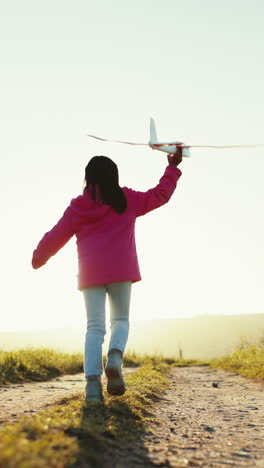 Child-in-field-with-plane-toy