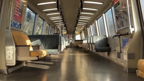 Pedestal-Shot-of-an-Aisle-of-an-Empty-Train-During-a-Bright-and-Early-Morning