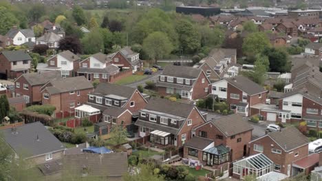 Quiet-British-homes-and-gardens-residential-suburban-property-aerial-view-push-in