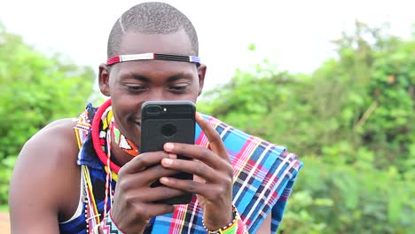 Maasai-man-enjoying-using-his-cellphone
