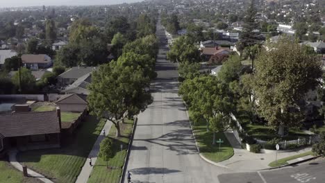 Burbank-city-suburb-in-summer,-people-bike-riding-and-driving,-California-aerial
