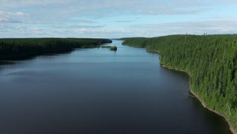 Aerial-shot-moving-up-on-a-superb-creek-showing-a-large-wild-lake-in-northern-Quebec