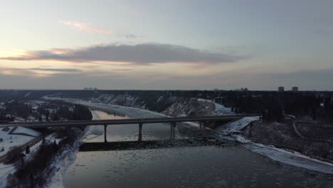 aerial-fly-over-dive-at-mini-small-iceberg-shards-at-birds-eye-view-towards-a-bridge-in-the-winter-on-the-North-Saskatchewan-river-in-Edmonton-Alberta-Canada-as-if-you-were-in-Iceland-at-sunset-awe2-2