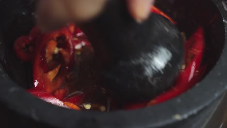 Mashing-sauce-ingredients-inside-black-ceramic-bowl
