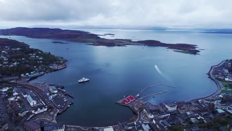 Establisher-aerial-shot-of-town-of-Oban-in-Scotland-with-port-and-ferry,-day