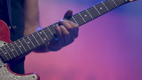 Man-in-rock-band-playing-electric-guitar-on-concert-stage,-Close-up-hand-shot