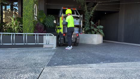 Postie-delivering-mails-and-parcels-in-the-latest-battery-operated-electric-vehicle,-Australia-Post-combatting-climate-change,-reducing-environmental-impact,-Brisbane,-capital-city-of-Queensland