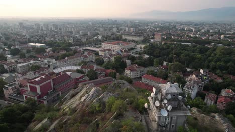 Establisher-aerial-of-city-of-Plovdiv,Bulgaria,-drone-stops-above-fountain-square