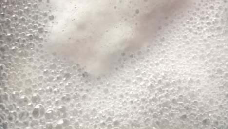 Close-up-overhead-view-of-boiling-,-bubbly-and-foamy-water