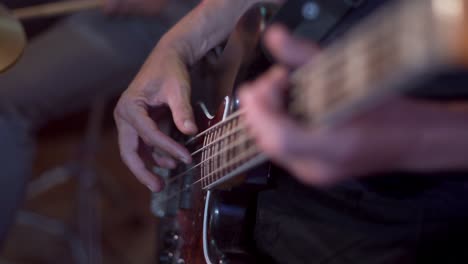 Slow-motion-close-up-of-an-electric-bass-guitar-being-played-finger-style-during-a-recording-session-with-a-slow-vibrating-string