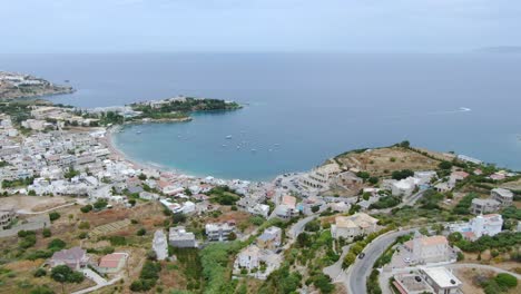 Idyllic-aerial-view-beach-town-and-turquoise-sea-bay-,-Crete-Island