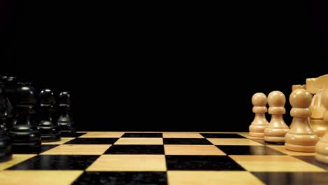 Dolly-shot-forward-along-chess-pieces-standing-on-either-side-of-a-chessboard-against-a-black-background