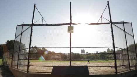 Empty-Baseball-Field-Diamond-in-the-Park,-Single-Person-Walks-by-Alone
