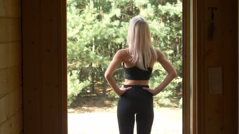 Back-View-Of-An-Active-Woman-On-Her-Sports-Wear-Ready-For-Jogging-On-A-Bright-Day-In-Arendel,-Zagorow-Poland-Near-Norwegian-Village