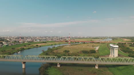 Drone-View-Of-Fujimi-Cityscape-From-Arakawa-River-In-Saitama,-Japan---aerial