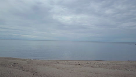 Empty-and-Endless-beach-an-Overcast-Day,-Dolly