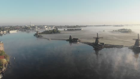 Drone-is-flying-arround-5-windmills-at-the-zaanse-schans-with-log-fog-Cinematic-Drone-Aerial-in-4K