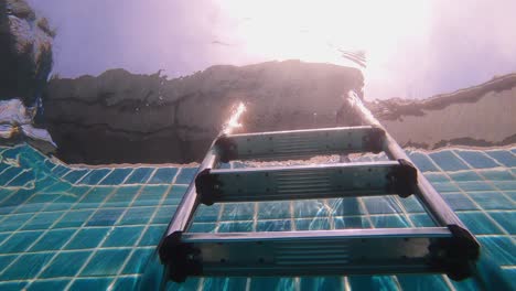 Pool-ladder-under-water,-bottom-view-slow-motion-60fps
