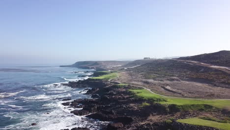 Drone-flys-left-to-right-with-large-wide-views-of-a-beachside-golf-course-and-Baja's-desert-landscape