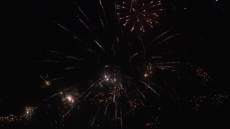 Colorful-Fireworks-in-the-sky-during-celebration---night-time-slow-motion
