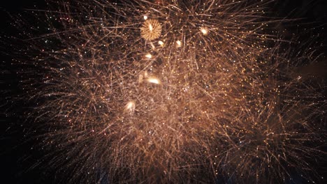 Sky-full-of-fireworks-during-concert-celebration---night-time-slow-motion