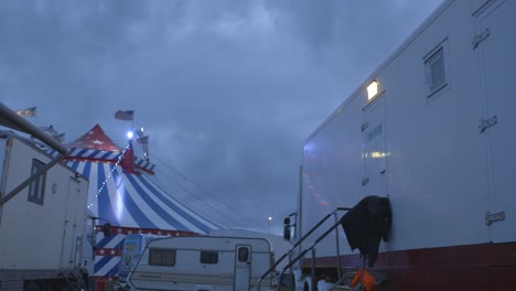 Circus-performers-caravan-in-the-foreground-with-circus-tent-at-the-back-at-night-time