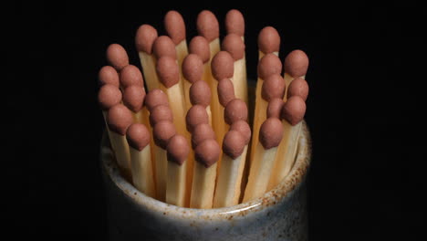 Pot-of-safety-matches-rotating-on-black-background