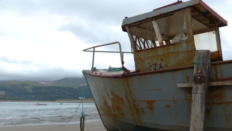 Relic-boats-on-the-beach-at-Barmouth,-Gwynedd,-Wales-UK