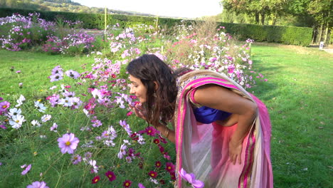 Beautiful-girl-smelling-flowers-in-a-park