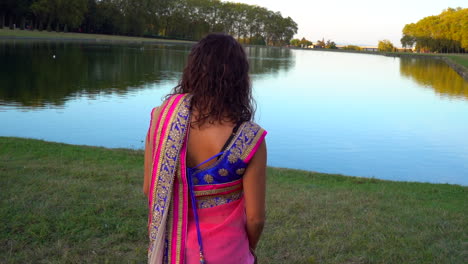 Back-view-of-a-girl-walking-to-a-lake
