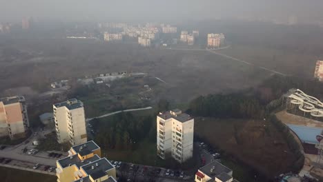 Flying-over-a-concrete-living-apartment-area-in-east-Europa-with-many-birds-flying-around-the-drone