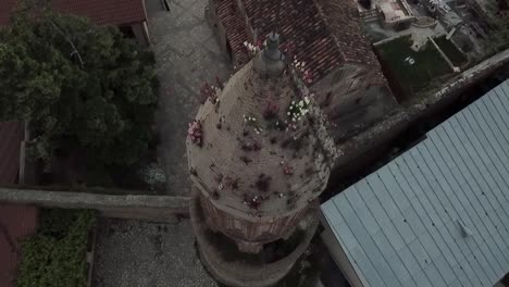 A-drone-shot-of-flowers-growing-on-the-top-of-the-church-in-Signagi