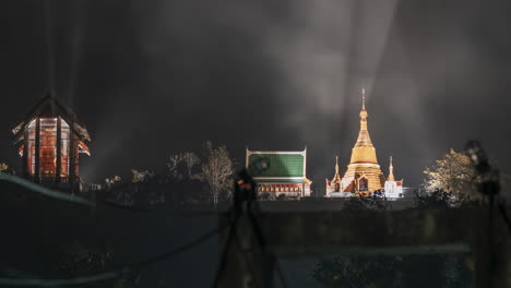 A-pre-dawn-time-lapse-of-a-Buddhist-monk-walking-across-a-suspension-bridge,-with-a-Hyper-Zoom-transition