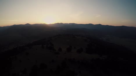 A-slow-descent-with-a-drone-over-the-hill-top-during-the-sunrise