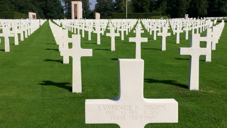 World-War-II-American-Cemetery-in-Luxembourg,-handheld-walk-past-grave-markers,-General-Patton's-grave-in-distance,-at-Battle-of-the-Bulge-site,-HD