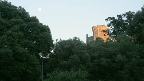 An-english-castle-peeks-above-the-trees-in-the-evening