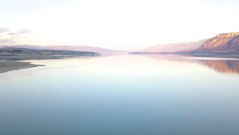 Forward-drone-shot-over-a-lake-in-Greece-during-golden-hour