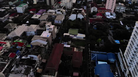 Aerial-Tilt-Up-Reveal-View-Of-Bangkok-At-Sunrise-–-BTS-Skytrain-Passing-By