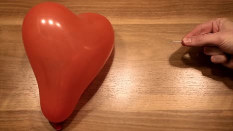 Symbol-of-broken-heart-no-love,-by-puncture-a-balloon-in-slow-motion