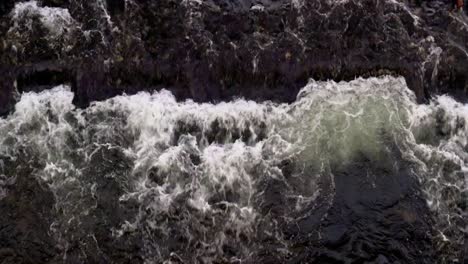 Water-in-the-river-flows-rapidly-and-strike-against-sand-bar-under-the-water-which-causes-whitewater-on-the-surface